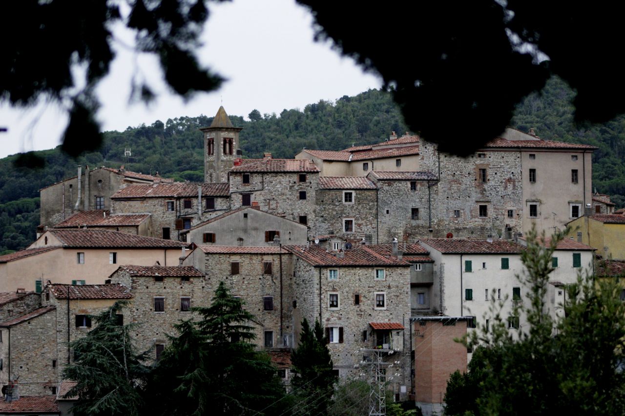 Charming old European village with rustic stone buildings and scenic landscape.